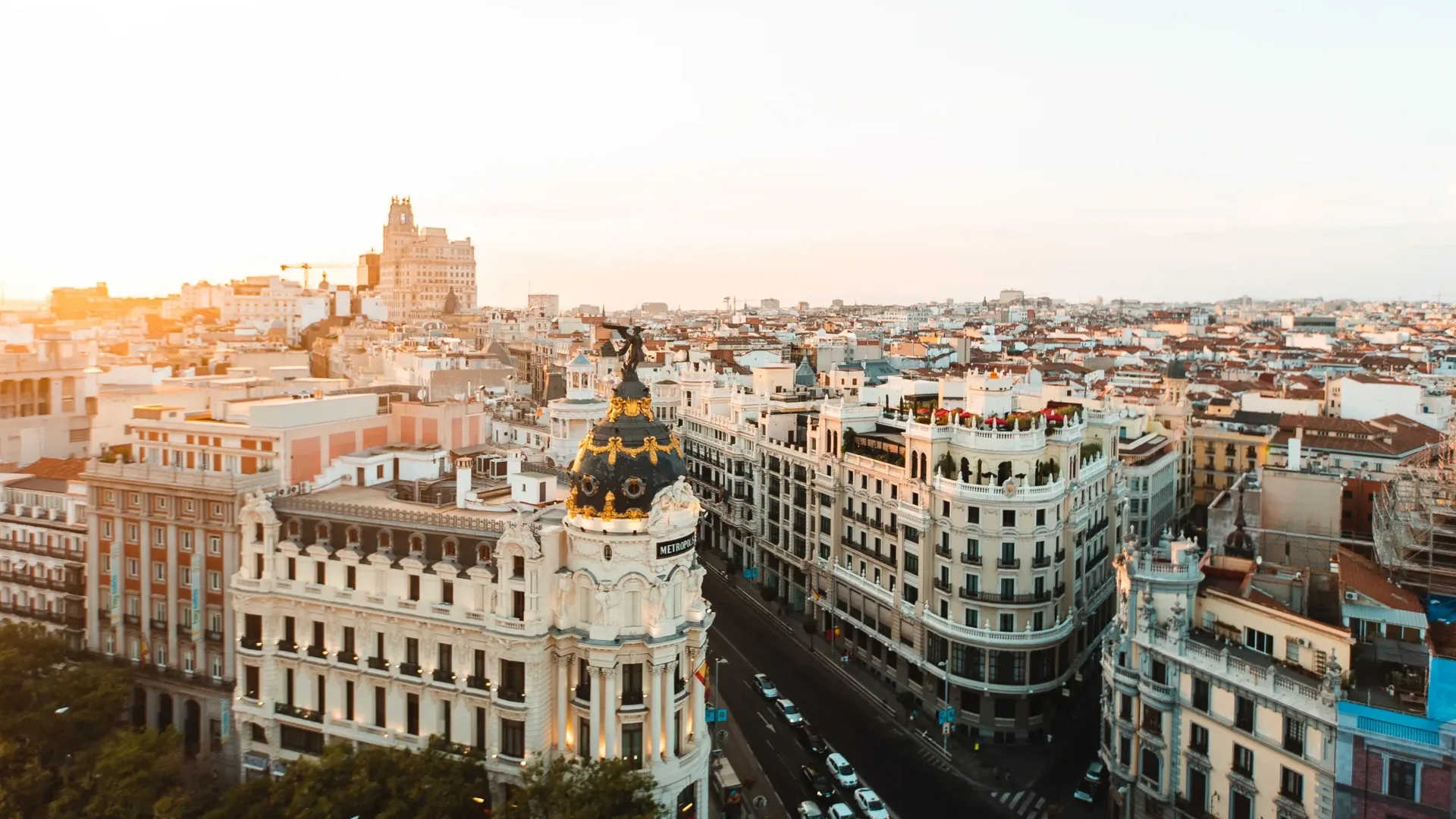 Gran Vía and the Metrópolis building in warm evening light over Madrid’s rooftops